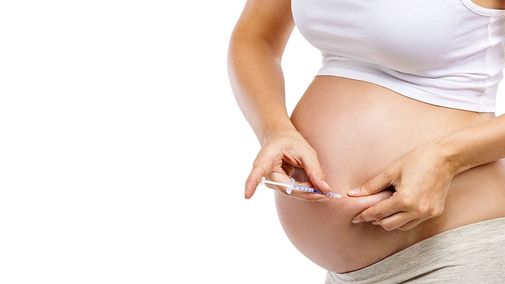 Pregnant woman with syringe